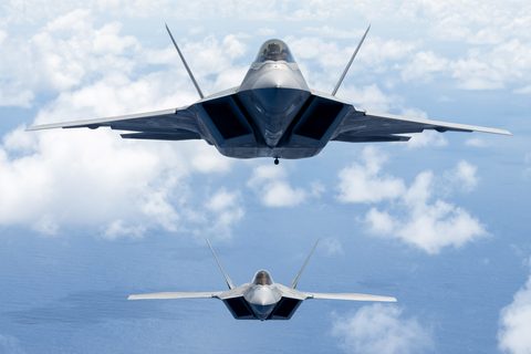 F-22 Raptors off Oahu by USAF / Emerson Nuñez — large framed print